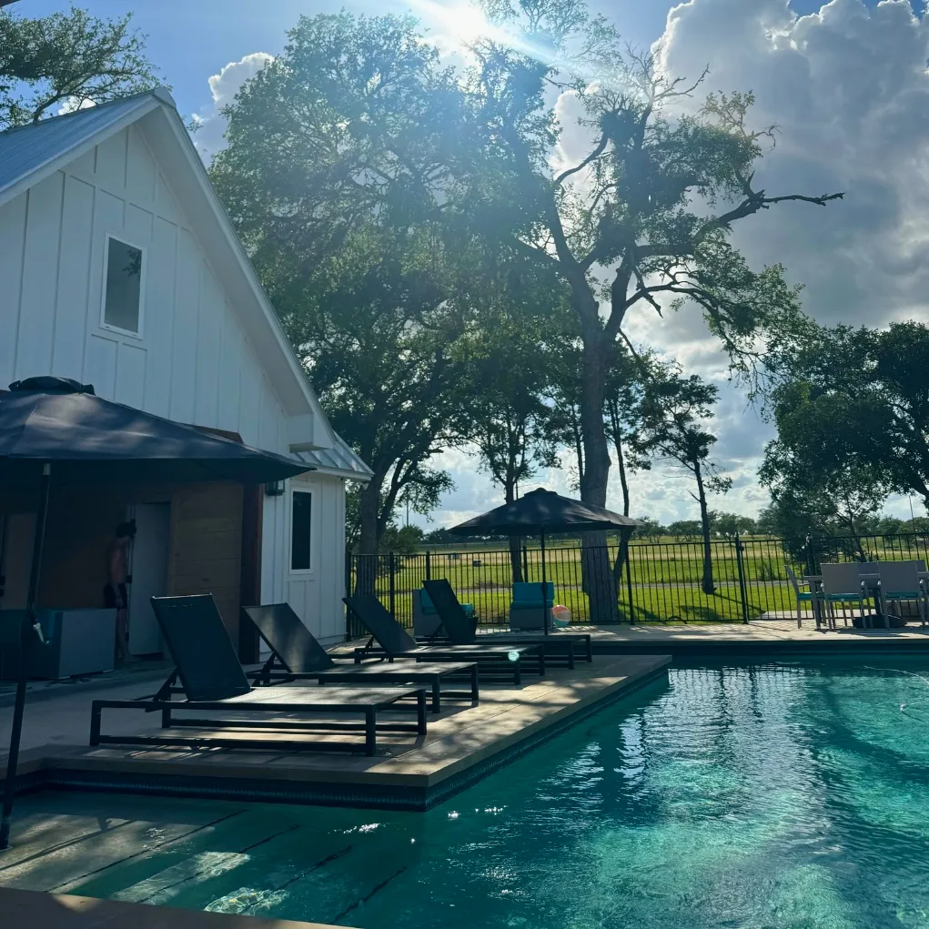 Social by Marly sample post: farmhouse pool and lounge chairs on a sunny day