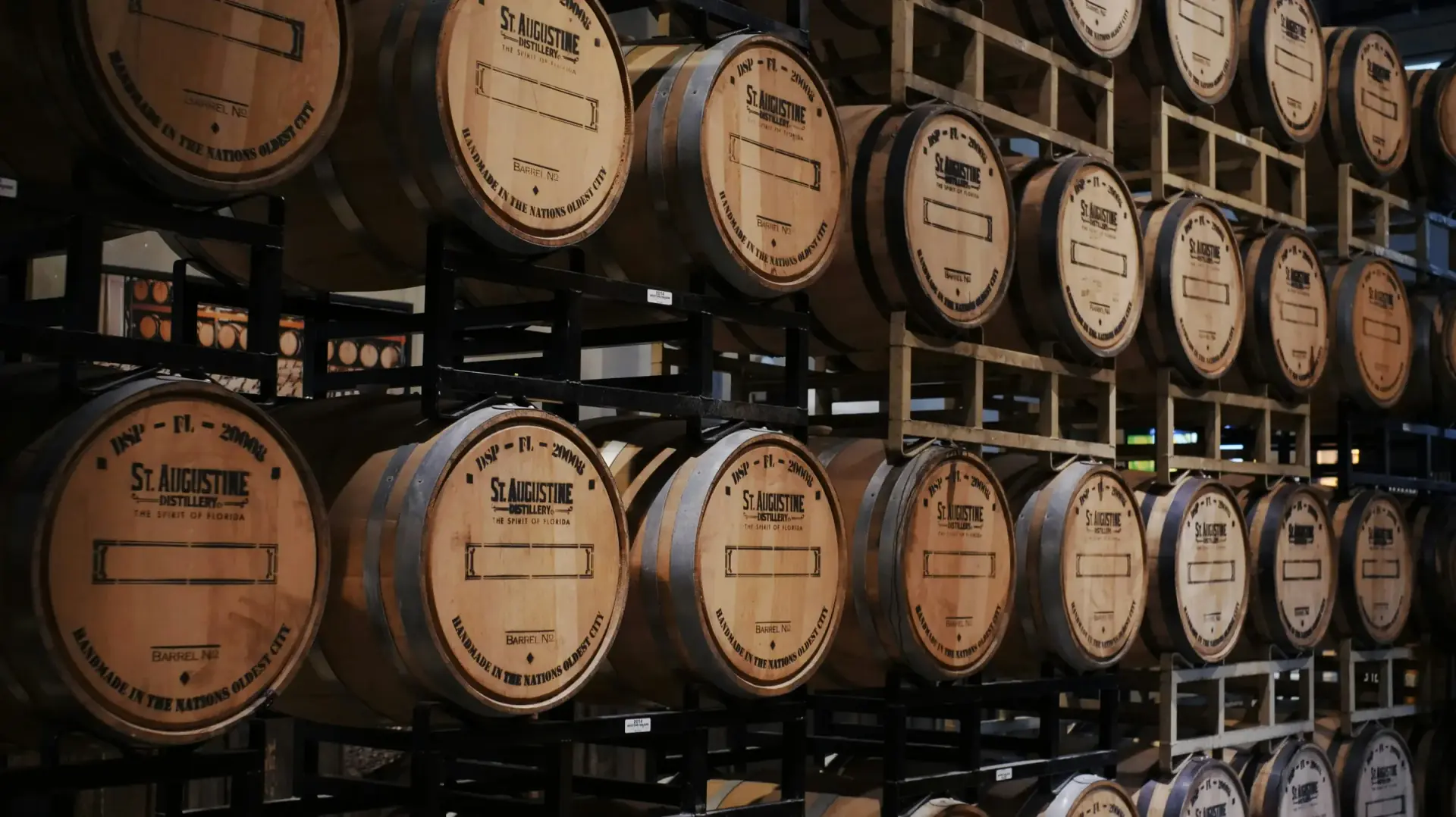 Whiskey barrels stacked on aging racks