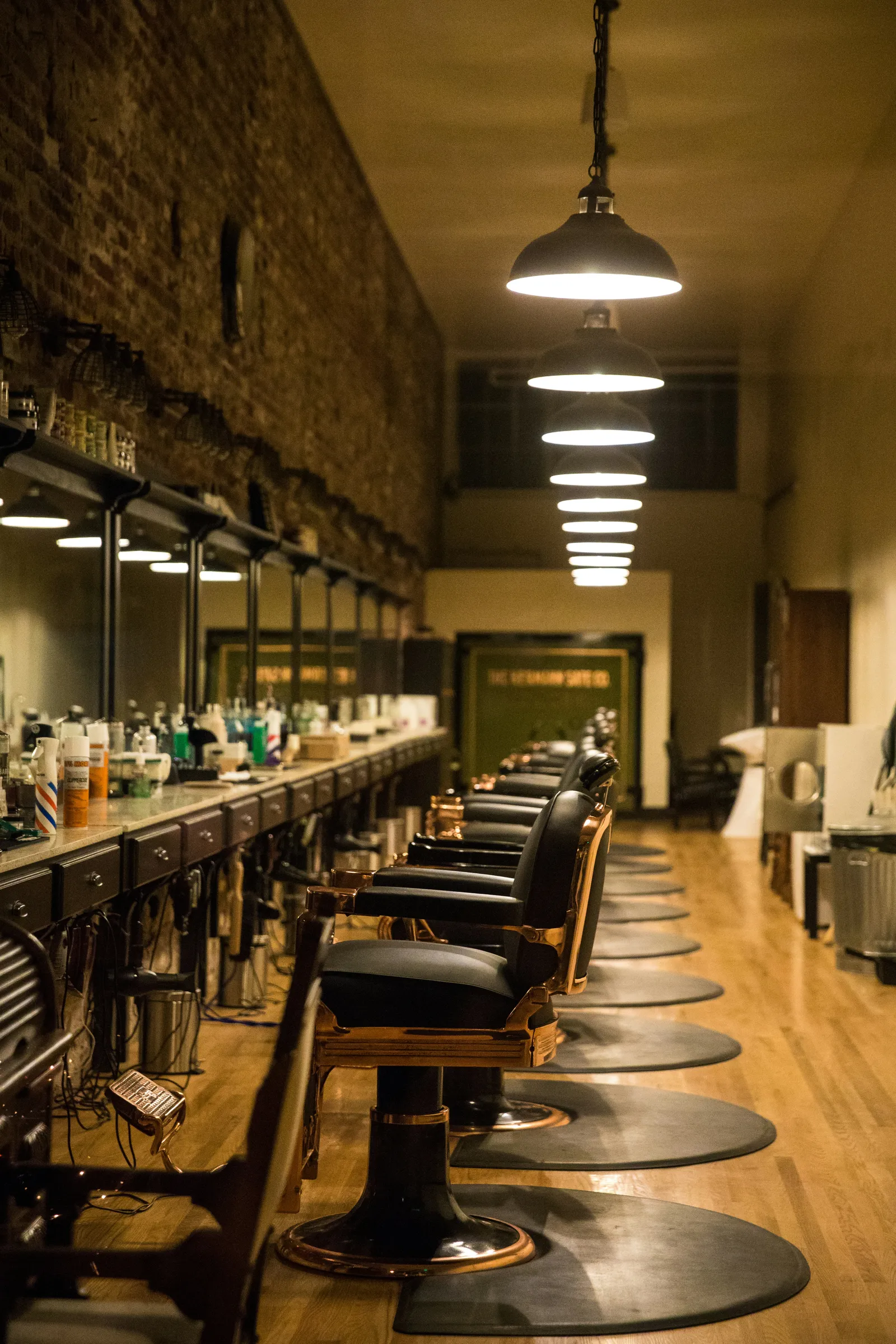 Vintage barbershop with leather chairs and a brick wall
